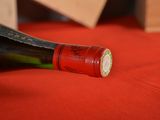 a bottle of wine sitting on a table with a knife