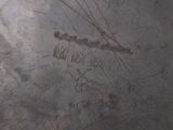 a close up of a metal plate with a writing on it