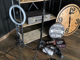 a wooden shelf with a clock and other items on top of it