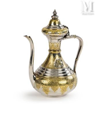 an antique silver and gold tea pot with a lid