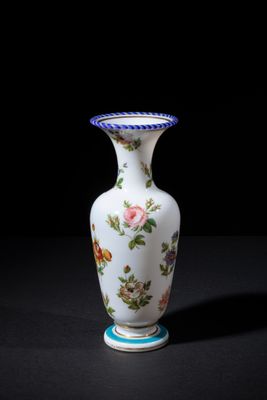 a white vase with a floral design on it