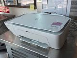 a white printer sitting on top of a metal table