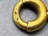 a gold ring that is on top of a table