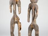 pair of carved figures of a man and a woman