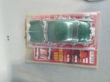 a green toy car sitting on top of a package