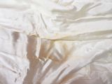 a bed with a white comforter and white sheets on it