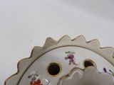 a close up of a white vase with flowers on it