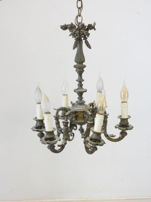 a chandelier with five lights hanging from the ceiling