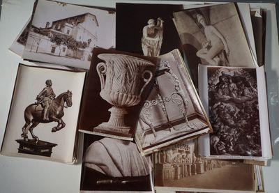 many old photos of a statue and a vase on a table