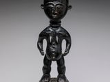 an image of a statue of a man standing on a wooden base