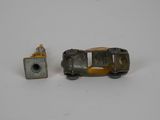 a small toy car next to a smaller toy car
