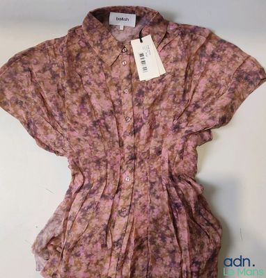 a close up of a shirt on a hanger on a wall