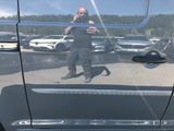 a man taking a picture of himself in the mirror of a car