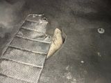 a piece of metal in the floor of a car