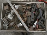 a wooden box filled with assorted tools on the floor