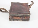 an old book that is sitting on a white surface