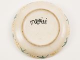 a white plate with a green and yellow design on it