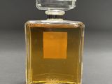 a close up of a bottle of perfume on a table