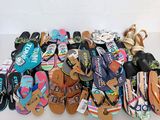 many pairs of flip flops that are on a table
