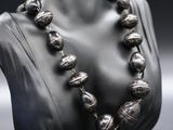 a close up of a necklace on a mannequin mannequin