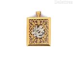 a close up of a gold and silver pendant on a white background