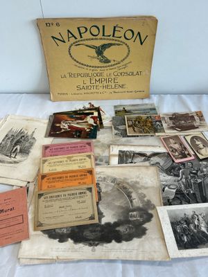 an old collection of books and pamphlets sitting on a bed