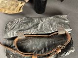 a bag and a cup on a table next to a hat
