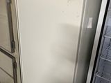 a white refrigerator in a kitchen next to a refrigerator freezer