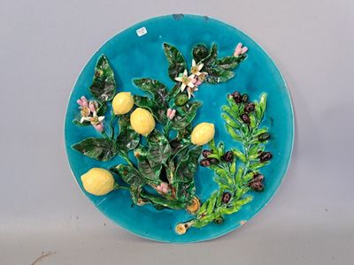 a blue plate with lemons and leaves on it