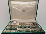 a green case with silverware in it on a table