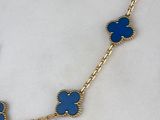 a close up of a necklace with blue flowers on it