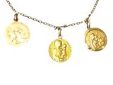 trois colliers composés de pièces d'or montées sur une chaîne et ornés d'une breloque en forme de pièce