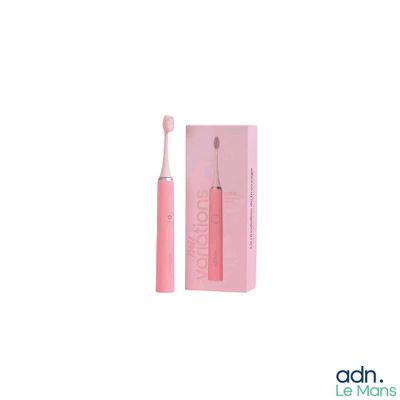 a pink toothbrush sitting in front of a pink box