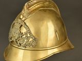 an antique gold helmet with a crown on top of it