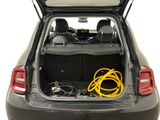 the back of a car with the trunk open and a hose in the trunk