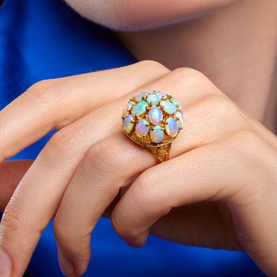 woman in blue shirt holding a ring with oplites on it