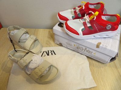 two pairs of shoes and a towel on a table