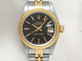 a close up of a wrist watch with a black dial