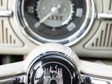 a close up of a steering wheel with a clock on it