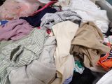 a large pile of clothes sitting in a white box