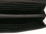 a black wallet with two zippers open on a white surface