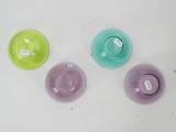 three different colored cups sitting on a white surface