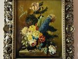 a picture of a painting of flowers in a gold frame