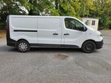 a white van parked in a parking lot with trees in the background