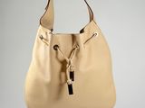 the large beige bag is hanging from a hook on the wall