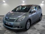 the silver toyota yaris is parked in a room with a checkered floor