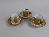 three coffee cups and saucers are sitting on a table