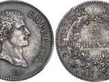 a silver coin with a bust of a man on it