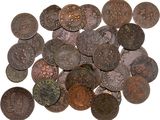 a pile of old coins on a white surface