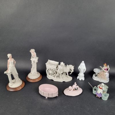 several figurines of different types and sizes on a black surface